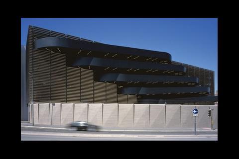 Four curvaceous car ramps burst out of the louvred east facade of Grosvenor's multistorey car park in Liverpool.